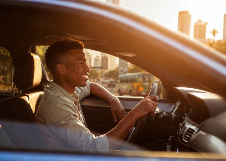 A driver standing by a car